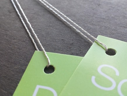 Lime green folded tags strung with 4-ply silver metallic lamé.