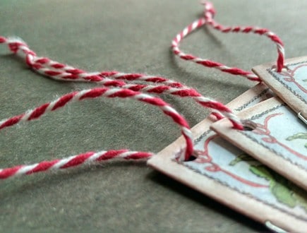 Stitched booklets strung with heavyweight variegated red-white cotton string.