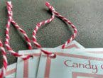 Tags strung with heavyweight variegated red-white cotton string.