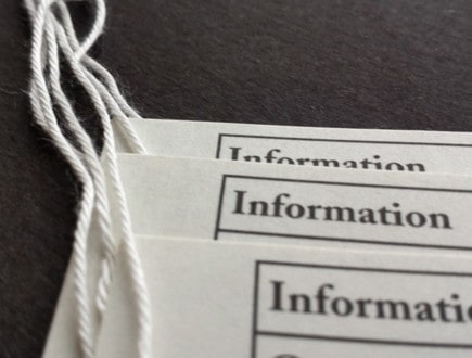 Economically made tags for institutional use strung with standard white rayon string.