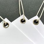 Tags of thick white cover stock reinforced with our antique brass eyelets and strung with our polished cord.
