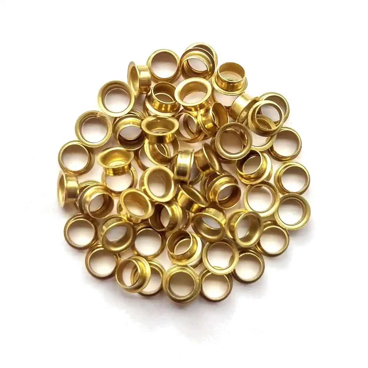 A pile of M&F Stringing's brass eyelets.