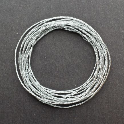 A coil of 3-ply silver metallic lamé.