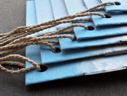 Blue booklets with cloud graphic strung with heavyweight bell cord.