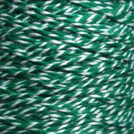 Spool of heavyweight variegated green-white cotton string.