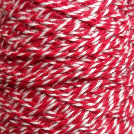 Spool of heavyweight variegated red-white cotton string.