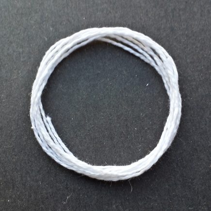 Photograph of a coil of lightweight 5/2 mercerized cotton in white.