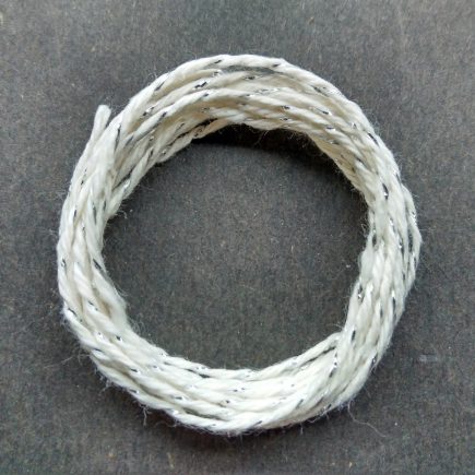 Coil of silver-white metallic yarn.