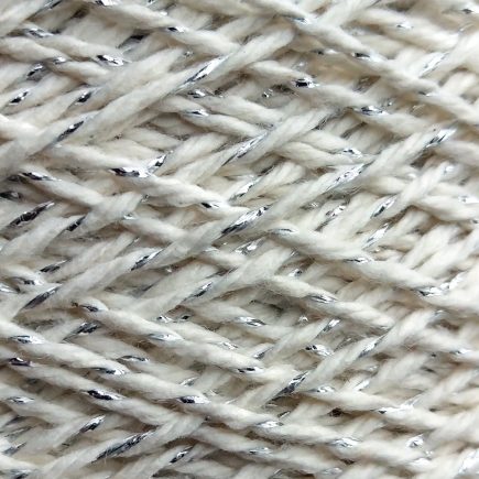 Spool of silver-white metallic yarn.
