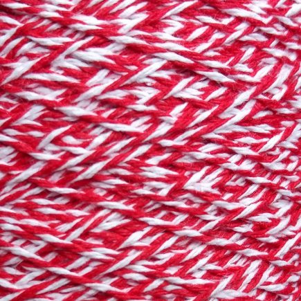 Spool of middle-weight variegated red-white cotton string.