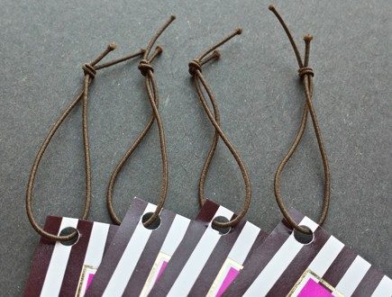 Brown and white striped tags strung with brown non-fray elastic.