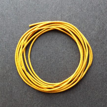 A coil of our gold non-fray elastic.