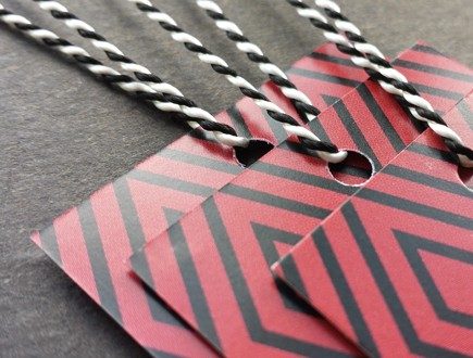Red and black geometric-patterned tags strung with our black-white variegated Pearlray.