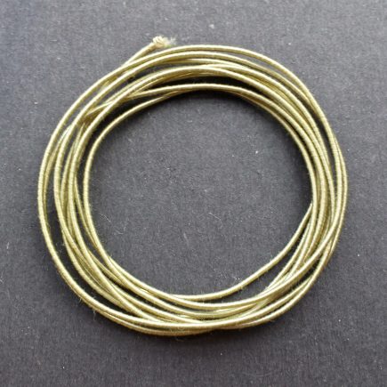 A coil of our standard elastic in antique gold.