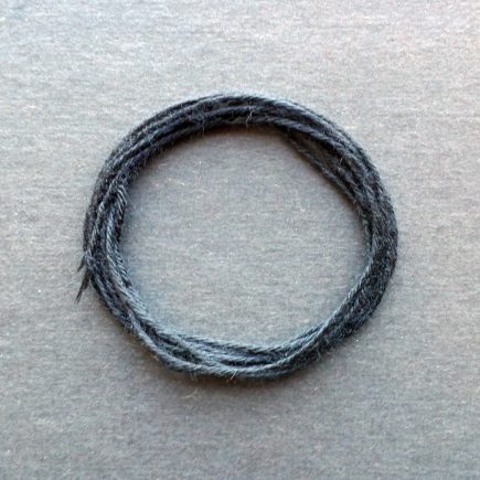 A coil of standard black rayon string.
